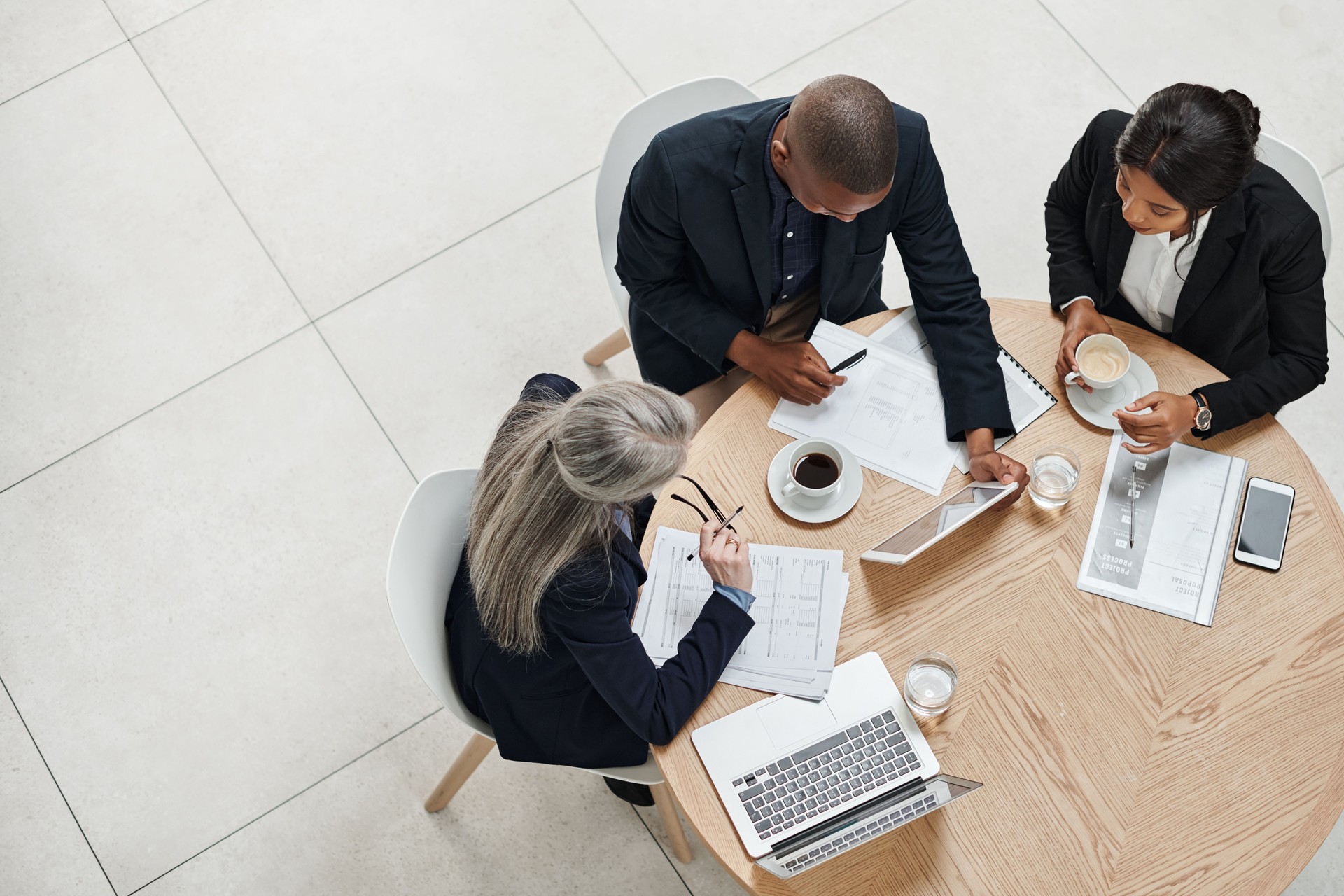 High angle shot of a group of businesspeople having a meeting in a modern office